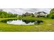 Scenic backyard view with pond reflecting the home and sky at 1020 Lair Ct, Westfield, IN 46074