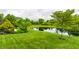 Backyard pond lined with lush landscaping at 1020 Lair Ct, Westfield, IN 46074