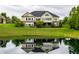 The backyard features a pond reflecting the home at 1020 Lair Ct, Westfield, IN 46074