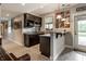 Basement bar with granite countertops, dark cabinets, and a view of the backyard at 1020 Lair Ct, Westfield, IN 46074