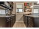 Granite countertops, dark cabinets, and sports memorabilia adorn this finished basement bar at 1020 Lair Ct, Westfield, IN 46074