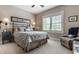 A serene bedroom featuring a decorative headboard, plantation shutters, and a comfortable upholstered chair at 1020 Lair Ct, Westfield, IN 46074