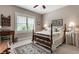 A cozy bedroom featuring a decorative rug, wooden furniture, and plenty of natural light from the large window at 1020 Lair Ct, Westfield, IN 46074