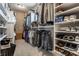 A well-organized walk-in closet with custom shelving, hanging rods, and ample storage space for shoes and clothes at 1020 Lair Ct, Westfield, IN 46074