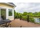 Outdoor deck with wooden floors, metal table and chair, and a serene view at 1020 Lair Ct, Westfield, IN 46074