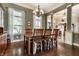 Elegant dining room featuring a chandelier, wood floors, and large windows for abundant natural light at 1020 Lair Ct, Westfield, IN 46074