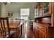 Classic dining room with hardwood floors, complemented by a wooden hutch and views into the open kitchen at 1020 Lair Ct, Westfield, IN 46074