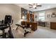 Carpeted exercise room with desk, chair, bookshelf, fan, and gym equipment at 1020 Lair Ct, Westfield, IN 46074