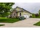 View of the house featuring yellow siding and brick details, along with an attached three car garage at 1020 Lair Ct, Westfield, IN 46074