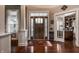 Inviting home foyer with gleaming hardwood floors, decorative rug, and elegant front door with sidelights at 1020 Lair Ct, Westfield, IN 46074