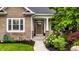 Charming home with a brick facade, inviting front porch, and beautifully landscaped flower beds at 1020 Lair Ct, Westfield, IN 46074