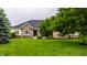 Beautiful brick and yellow siding home with a large, well-manicured green lawn and mature trees at 1020 Lair Ct, Westfield, IN 46074