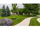 Charming brick and yellow siding home with a winding sidewalk leading to the front door, framed by lush greenery at 1020 Lair Ct, Westfield, IN 46074