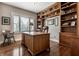 Spacious home office features custom wooden built-in shelving and large wooden executive desk at 1020 Lair Ct, Westfield, IN 46074