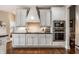 Bright kitchen with white cabinetry, stainless steel appliances, and a stylish range hood at 1020 Lair Ct, Westfield, IN 46074