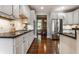 Kitchen with white cabinets, stainless appliances, hardwood floors, and granite countertops at 1020 Lair Ct, Westfield, IN 46074