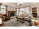 Open-concept living room with fireplace, hardwood floors, and view into dining area at 1020 Lair Ct, Westfield, IN 46074