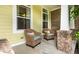 Covered front porch with two wicker chairs and a small table, creating a cozy outdoor living space at 1020 Lair Ct, Westfield, IN 46074