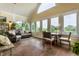 Bright sunroom with tile floors, multiple windows, and a vaulted ceiling, perfect for relaxation at 1020 Lair Ct, Westfield, IN 46074