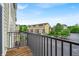 Balcony view of condo neighborhood, surrounded by lush greenery and a clear blue sky at 1064 Reserve Way, Indianapolis, IN 46220