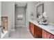 Bathroom with double vanity, ceramic tile flooring and modern lighting at 1064 Reserve Way, Indianapolis, IN 46220