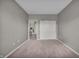 Bedroom with carpet and white closet doors featuring a doorway to an adjacent room at 1064 Reserve Way, Indianapolis, IN 46220