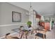 An open-concept dining area showcases a glass table set and flows into a kitchen at 1064 Reserve Way, Indianapolis, IN 46220