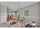 The dining room features a glass table set, modern light fixture and flows into the kitchen at 1064 Reserve Way, Indianapolis, IN 46220
