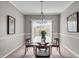 Dining room with a glass table set and modern chandelier, bathed in natural light at 1064 Reserve Way, Indianapolis, IN 46220