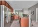 Well-lit kitchen featuring stainless steel appliances and tiled flooring at 1064 Reserve Way, Indianapolis, IN 46220