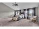 Bright primary bedroom boasts large windows, a ceiling fan, and neutral tones at 1064 Reserve Way, Indianapolis, IN 46220