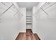 Bright walk-in closet with wire shelving and hardwood floors offers ample storage space at 1064 Reserve Way, Indianapolis, IN 46220