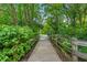 Scenic walkway with wooden fences and lush greenery leads to a beautiful community area at 1064 Reserve Way, Indianapolis, IN 46220
