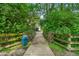 Picturesque walkway lined with vibrant greenery, with a glimpse of a building in the distance at 1064 Reserve Way, Indianapolis, IN 46220