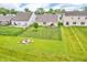 Aerial view of the home's fenced backyard, patio with grill, lawn and fire pit, backing up to neighborhood with pond at 10731 Jimmy Lake Dr, Indianapolis, IN 46239