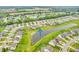 Beautiful aerial view of homes situated along a serene pond, creating a peaceful community ambiance at 10731 Jimmy Lake Dr, Indianapolis, IN 46239