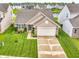 Aerial view of a well-maintained home showcasing its manicured lawn, landscaping, and inviting curb appeal at 10731 Jimmy Lake Dr, Indianapolis, IN 46239