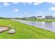 Tranquil backyard view with lush green lawn and pond, offering a serene and picturesque setting for outdoor enjoyment at 10731 Jimmy Lake Dr, Indianapolis, IN 46239