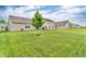 This backyard has a lush lawn and mature trees, offering a serene and private outdoor retreat at 10731 Jimmy Lake Dr, Indianapolis, IN 46239