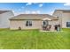 A spacious backyard with a patio, grill, and lush green grass, creating an ideal outdoor living space at 10731 Jimmy Lake Dr, Indianapolis, IN 46239