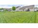 Expansive backyard featuring well-maintained lawn, landscaping, and a patio area, perfect for outdoor activities and relaxation at 10731 Jimmy Lake Dr, Indianapolis, IN 46239