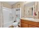 Bathroom features tub-shower combo, wood cabinet, and tan walls at 10731 Jimmy Lake Dr, Indianapolis, IN 46239