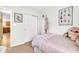 Bedroom with pastel pink decorations, carpet floors, and white closet doors at 10731 Jimmy Lake Dr, Indianapolis, IN 46239