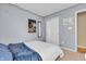 Bedroom with blue accent blanket, white closets and light gray walls at 10731 Jimmy Lake Dr, Indianapolis, IN 46239