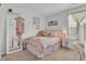 A bedroom with a pastel pink bedding, stuffed animals, and a large mirror at 10731 Jimmy Lake Dr, Indianapolis, IN 46239