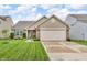 Well-maintained home featuring a lush lawn, a two-car garage, and attractive landscaping at 10731 Jimmy Lake Dr, Indianapolis, IN 46239