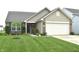 Charming home with a brick facade, manicured lawn, and a two-car garage at 10731 Jimmy Lake Dr, Indianapolis, IN 46239