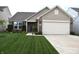 Charming single-Gathering home featuring well-manicured lawn, flower beds, brick accents, and attached two-car garage at 10731 Jimmy Lake Dr, Indianapolis, IN 46239