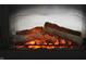 Close-up of a realistic electric fireplace with glowing logs, set within a dark metal frame at 10731 Jimmy Lake Dr, Indianapolis, IN 46239