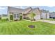 Well-maintained front yard featuring lush green lawn and landscaping, framing a charming home at 10731 Jimmy Lake Dr, Indianapolis, IN 46239